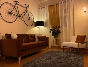 蒙特普利斯尚伯德Logis Hôtel Le Saint Florent的客厅配有沙发,墙上有自行车