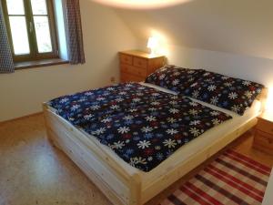 雷吉维兹Chalupa Rejvíz的一间卧室配有一张带花卉床罩的床