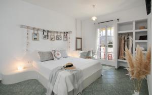 加里尼"Palatiana Agriturismo-Philoxenia Cottages", Private Nature Retreats的白色卧室,配有白色的床和帽子