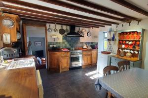 EltonWestdale Cottage, Elton in the Peak District的厨房配有木制橱柜和炉灶烤箱。