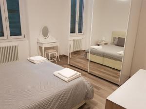 热那亚米姆公寓的一间小卧室,配有两张床和镜子