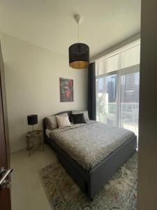 迪拜Wonderful Reva Aparthotel Downtown的一间卧室设有一张床和一个大窗户