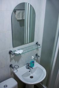 陶格夫匹尔斯Olimpija Hotel & SPA的一间带水槽、镜子和卫生间的浴室