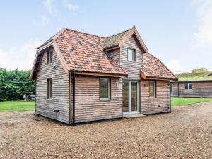 MeophamBrindleshaw Barn的一座带橙色屋顶的小木房子