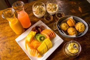 巴卢莱自然保护区恩祖韦尼野味旅舍的一张桌子,上面放着一盘食物和一杯橙汁