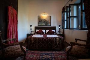 安塔利亚哈德里安那斯酒店的一间卧室配有一张床和两把椅子