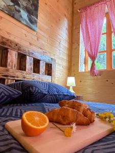 普利特维采湖Wooden house with a waterfall "Stipanov mlin"的床上的切纸板,夹着橙子