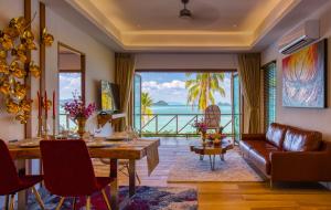 瑶亚岛Coconut Grove Resort的客厅配有桌子和沙发