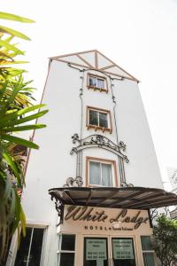 曼谷White Lodge Hotel Bangkok的一座建筑的顶部有一个钟楼