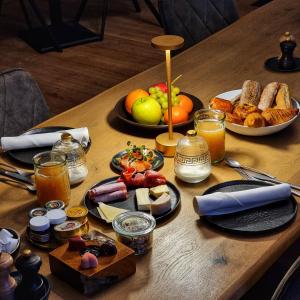 HeikruisB&B T'Rest - Park ter Rijst的餐桌上放有食物和水果盘