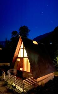 卡索尔Aloha Riverside的一间小屋,晚上有灯光屋顶