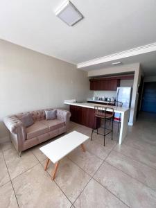 布宜诺斯艾利斯Hermoso depto con amenities en Belgrano的带沙发和桌子的客厅以及厨房。