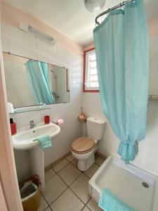 圣吉尔莱班海滩酒店的一间带卫生间、水槽和镜子的浴室