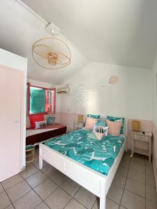 圣吉尔莱班海滩酒店的一间卧室配有一张白色的床和绿色的被子
