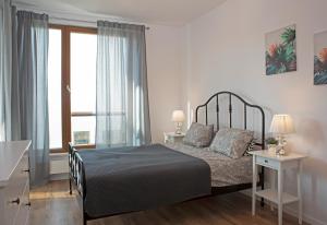 格但斯克Luxus Apartament Rodzinny z sauną i siłownią的一间卧室设有一张床和一个大窗户