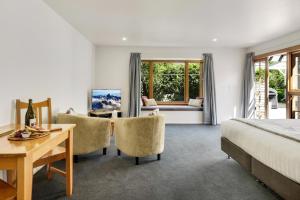 汉默温泉哈罗盖特花园汽车旅馆的卧室配有一张床、一张桌子和椅子
