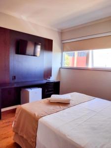 ParanavaíHotel Itália的卧室配有白色的床和窗户。