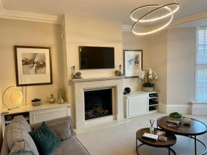 鲍内斯温德米尔Edge Mere Apartment, Bowness-on-Windermere的带沙发和壁炉的客厅