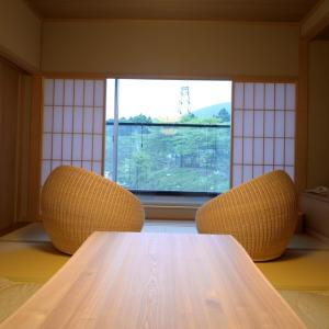 箱根Hakone Gora Byakudan的窗户间里的一张桌子和两把椅子