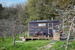 多切斯特Orchard retreat off grid shepherds huts in Dorset的小屋设有2把椅子和甲板