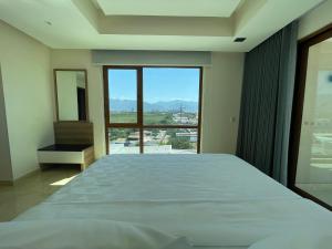 巴亚尔塔港Holiday Inn & Suites - Puerto Vallarta Marina & Golf, an IHG Hotel的一间卧室设有一张大床和一个大窗户