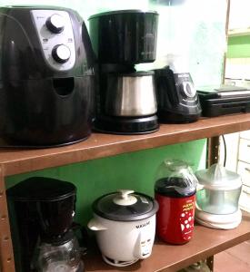 纳塔尔Pousada Cisne Branco的一个带咖啡壶和电器的架子