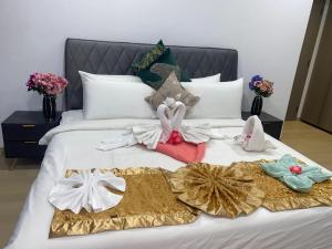吉隆坡Eaton Residences KLCC by Luna的一张床上挂着一束衣服