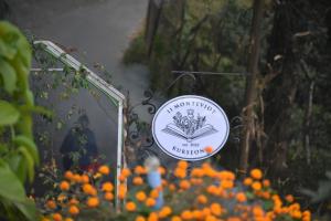 Kurseong11 Monteviot: Luxury homestay overlooking a tea estate的橙花花园的标志