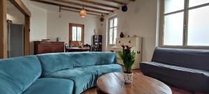 里摩日Le sas de Fanny - chambres d'hôtes的客厅配有蓝色的沙发和桌子
