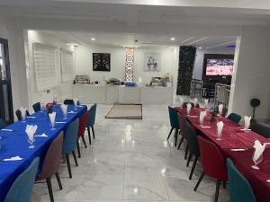 努瓦迪布Hôtel Esma Nouadhibou的宴会厅配有蓝色的桌椅和柜台