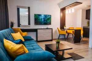 塞格德奥利斯酒店的客厅配有蓝色的沙发和桌子