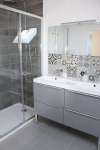 圣马丁贝鲁T4 Meublé de 105m2 axe Annecy-Geneve的浴室配有白色水槽和淋浴。
