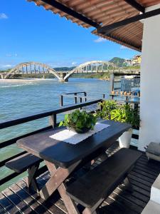 里约热内卢Casa Marambaia 2的享有河流和桥梁景致的野餐桌