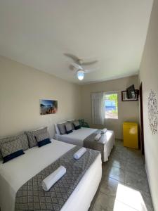 乌巴图巴Pousada Serrate的一间带两张床和一张沙发的卧室