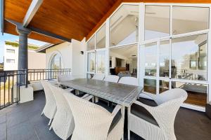 曼哲拉Beachfront Family Favourite Home with Pool & Views的一间带桌椅的用餐室