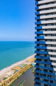 巴统Batumi Inn Aparthotel With Sea View的俯瞰海滩和大海的高楼