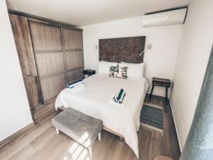 格兰德凯斯PARADISE VIEW 1 bed-room water front studio at Grand Case的卧室配有一张白色的大床,铺有木地板