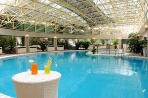 北京金龙建国温泉酒店的一个带2杯饮料的游泳池