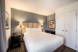 圣克拉拉Sonesta Simply Suites Silicon Valley Santa Clara的酒店客房带一张大床,带白色床单
