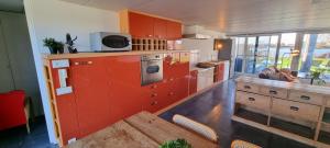 拿撒勒Cozy house at the lake的一个带红色橱柜和桌子的大厨房