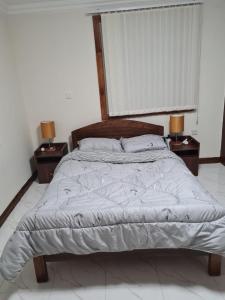 MuhoroniKoru Farm Retreat的一间卧室配有一张带2个床头柜的大床