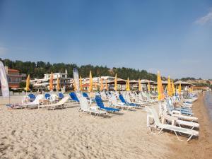 阿吉亚特拉萨阿尔米拉酒店的海滩上的一组椅子和遮阳伞