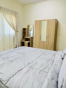 Al FanātīrFANATEER SUDAYER VILLA的卧室设有一张白色大床和一扇窗户。
