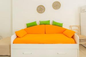 都灵[Stellantis-Alpitour] Casa Tucano的卧室内的橙色床和绿色枕头