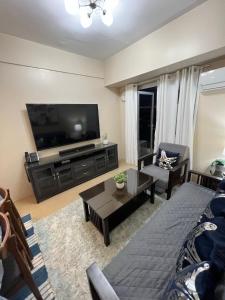 伊洛伊洛Cozy 2 Bedroom Condo with Balcony for Rent的客厅配有大屏幕平面电视