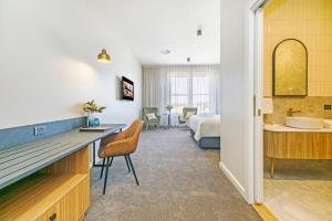 塔南达The Tanunda Club Guest Suites的酒店客房设有浴室和卧室