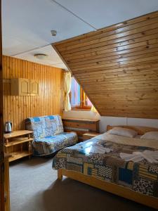 波罗维茨巴尔别墅酒店的一间卧室配有两张床,卧室内配有沙发