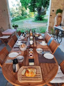 La MarcheChambre d'hôtes "Au bord de Loire"的一张长木桌子,上面有食物