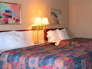伊登Shayona Inn - Eden的酒店客房设有两张床和两盏灯。