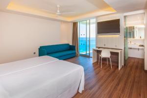 贝尼多姆贝尼多姆港口温泉酒店的酒店客房配有床、沙发和电视。